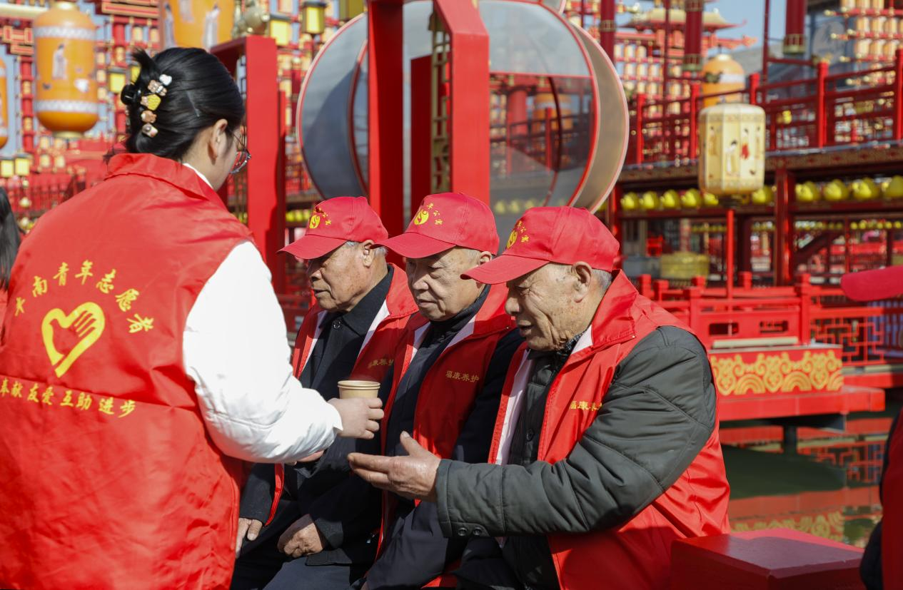 豐南青年志愿者在河頭老街景區(qū)為老人服務(wù)。陳軍攝